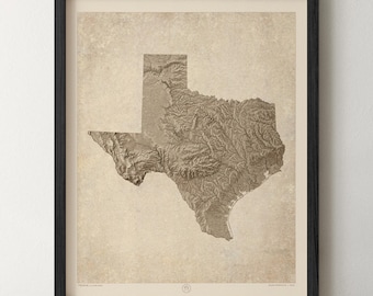 May include: A framed wall art print featuring a detailed topographical relief map of Texas in shades of brown and beige. The map displays the state's terrain with textured shading against a vintage-style parchment background, enclosed in a black frame.