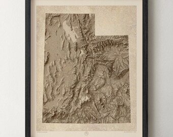 May include: A framed topographic map print of the state of Utah in shades of beige and brown. The map features detailed relief shading showing mountain ranges and valleys, set against a textured parchment-style background within a black frame.