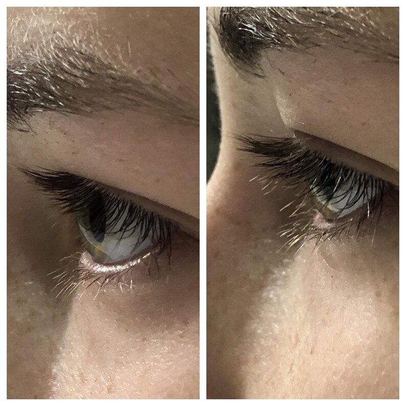 May include: Close-up of a human eye with long, dark eyelashes and a light-colored iris. The eyebrow above is also dark. The skin around the eye is light-toned, with subtle shadows and textures. The image is well-lit, highlighting the details.
