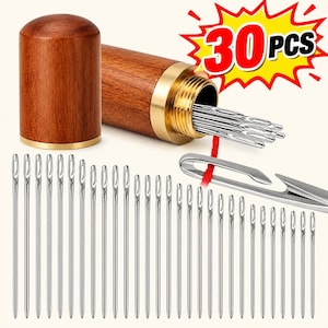 May include: A set of 30 silver metal sewing needles with a wooden storage case featuring a brass screw-top lid. The needles are long and thin with elongated eyes, and one needle is shown with a red thread. The text 30 PCS is visible.