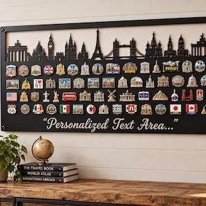 May include: A rectangular black metal wall display board featuring a laser-cut city skyline silhouette at the top and rows of various colourful travel souvenir pins attached to the surface. The text "Personalized Text Area..." is printed in white.