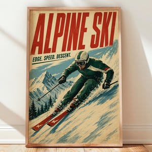 May include: A framed vintage-style poster titled ALPINE SKI with the text EDGE. SPEED. DESCENT. The illustration depicts a skier in a dark green suit and white helmet skiing down a snowy mountain slope with pine trees and peaks in the background.