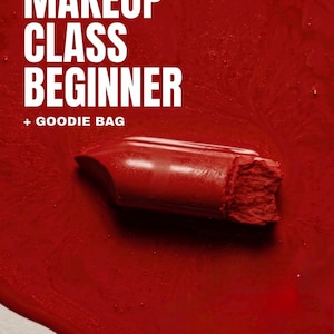 May include: A red lipstick bullet resting on a pool of matching red liquid. The white text reads MAKEUP CLASS BEGINNER + GOODIE BAG. The composition features a bold, monochromatic red color scheme with a glossy, viscous texture surrounding the lipstick.