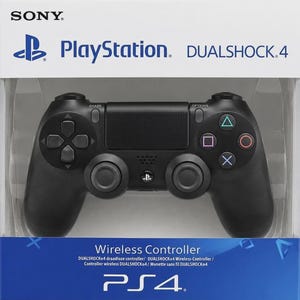 May include: A black Sony PlayStation DualShock 4 wireless controller in its original packaging. The controller features a directional pad, two analog sticks, a central touchpad, and action buttons with triangle, circle, cross, and square symbols.