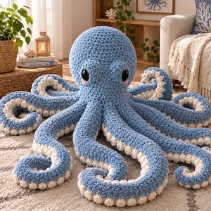 May include: A large, soft, crocheted octopus plush toy featuring a textured light blue yarn body and eight sprawling tentacles. The underside of each tentacle is lined with small, round, cream-colored crocheted suckers. It has two large, glossy black eyes.