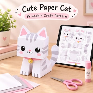 Puede incluir: Una figura de gato de papel con rayas grises, orejas rosas y un collar rosa con un cascabel amarillo. Junto a ella hay una tableta con un patrón de manualidades, tijeras rosas y un pegamento. El texto dice Cute Paper Cat Printable Craft Pattern.