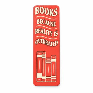 May include: A rectangular red bookmark featuring the cream-colored text "BOOKS BECAUSE REALITY IS OVERRATED" arranged in four lines. Below the text, a graphic illustration depicts three upright books in cream and red colors.