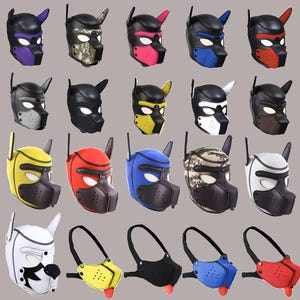 May include: A collection of twenty dog-themed masks and muzzles in various colours and patterns. The masks feature pointed ears, eye cutouts, and a snout section with ventilation holes. Some designs include solid colours like red, blue, yellow, and white.