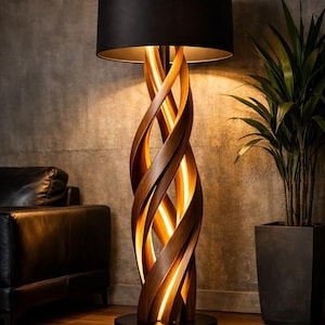 May include: A floor lamp featuring a dark brown wooden base with a spiraling, twisted design that illuminates from within. The lamp is topped with a large, cylindrical black fabric lampshade and stands on a circular black metal base.