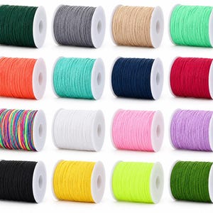 May include: Sixteen spools of cord in various solid colors including dark green, gray, beige, mint, orange, teal, navy, red, multicolored, white, pink, purple, black, yellow, neon yellow, and grass green on white plastic reels.