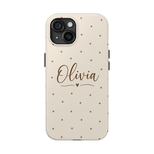 May include: A cream-coloured smartphone case featuring a pattern of small brown polka dots. The name Olivia is printed in a brown cursive script in the centre, positioned above a small brown heart icon and a decorative horizontal line.
