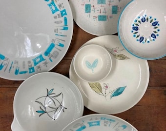 May include: A set of vintage blue and white ceramic dinnerware with various patterns. The set includes a large dinner plate, a salad plate, a soup bowl, and a small bowl.