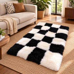 May include: A rectangular area rug featuring a high-pile, shaggy texture with a repeating black and white checkered pattern. The rug is composed of alternating square blocks of solid black and solid white fibers, creating a bold, high-contrast design.