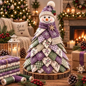 May include: A fabric snowman figurine featuring a layered, tree-shaped body made of quilted purple, green, and white patterned fabric patches. The snowman wears a matching purple knit hat with a pom-pom and a scarf with a wooden snowflake accent.