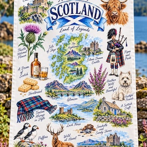 May include: A white tea towel featuring a colorful map of Scotland surrounded by illustrations of Edinburgh Castle, a Highland cow, a bagpiper, a thistle, shortbread, a bottle of Scotch, a tartan blanket, puffins, a deer, and a Westie.