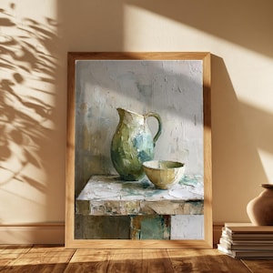 May include: A framed oil painting depicting a green and blue ceramic pitcher and a small matching bowl resting on a textured surface. The artwork features thick, visible brushstrokes in shades of white, cream, green, and blue, creating a still life.