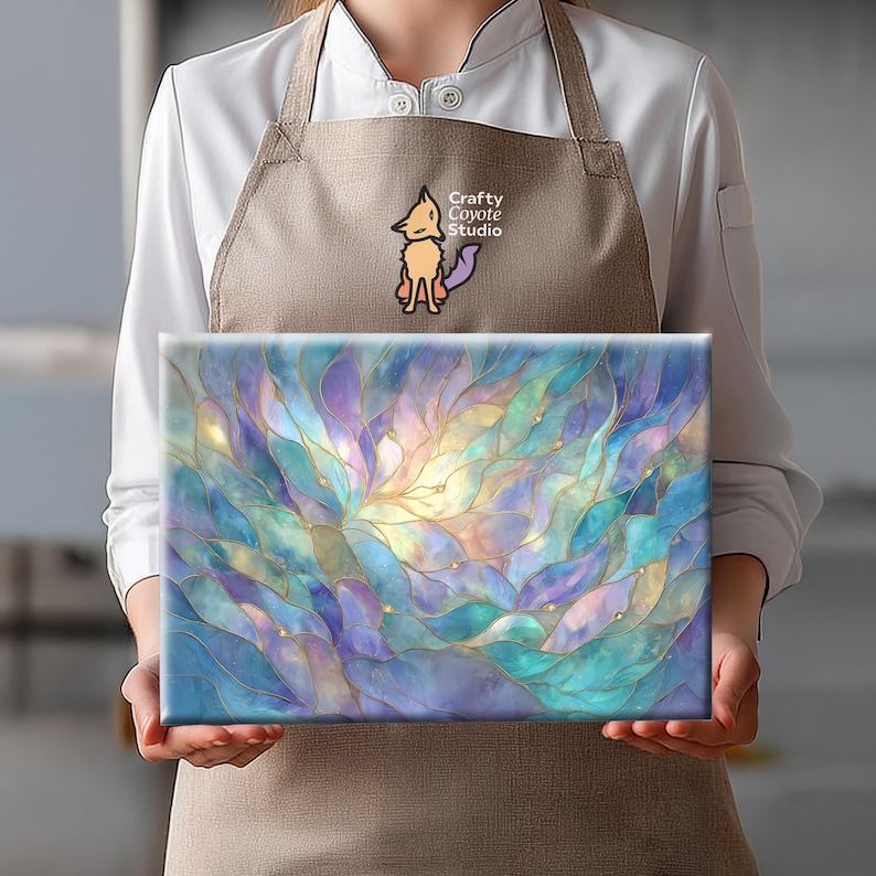 May include: A rectangular canvas print featuring an abstract design of layered, flowing shapes in shades of blue, purple, and gold. The artwork has a watercolor effect, with a central light source. The print is held by a person wearing a brown apron.