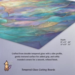 May include: Tempered glass cutting board with a colorful abstract design in shades of blue, teal, and gold. The board has rounded corners and a textured surface. The depth is 8" x 11" .24" and 11" x 15" .31". The text says "Tempered Glass Cutting Boards".