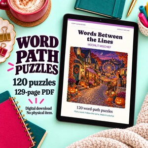 May include: A digital tablet displaying a book cover titled Words Between the Lines by Moonlit Mischief, featuring a colorful autumn village scene with pumpkins and a ferris wheel. The text indicates 120 word-path puzzles and a 129-page PDF format.