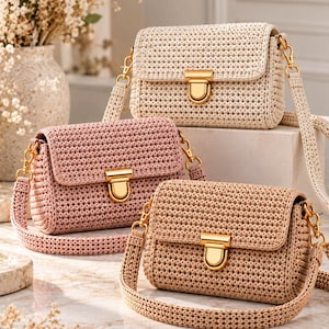 May include: Three rectangular crochet crossbody bags in cream, dusty pink, and tan. Each bag features a textured woven pattern, a gold-tone metal push-lock closure on the front flap, and a matching crochet shoulder strap attached with gold clips.