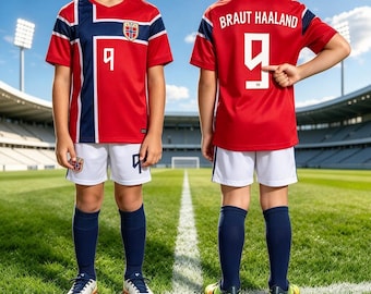 May include: A red, white, and blue soccer jersey featuring the Norwegian flag emblem and the number 9 on the front, paired with white shorts and navy blue socks. The back of the jersey displays the name BRAUT HAALAND and the number 9.