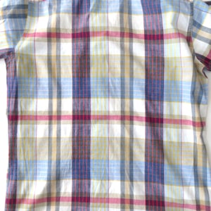 May include: A white button-down shirt with a plaid pattern in shades of blue, yellow, red, and brown.