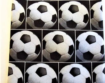 May include: Black and white soccer ball pattern. The design features a grid of soccer balls, each with white pentagons and black hexagons. The repeating pattern creates a sporty and geometric aesthetic. The image is suitable for sports-themed products.