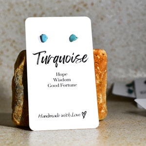 May include: Turquoise earrings on a white card with the text "Turquoise", "Hope", "Wisdom", "Good Fortune", and "Handmade with Love".