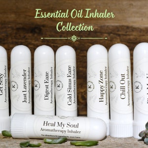 May include: A collection of ten white essential oil inhalers with different labels. The labels include names like "Get Sexy", "Just Lavender", "Digest Eaze", "Cold Sinus Eaze", "Happy Zone", "Chill Out", and "Heal My Soul".