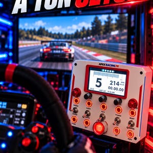 May include: A racing simulator control panel with a digital display showing speed and gear, labeled APEX RACING FR. The white unit features multiple red toggle switches and buttons, set against a background with a racing game screen.
