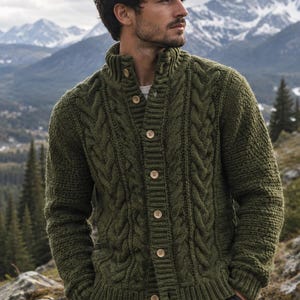 May include: An olive green cable-knit cardigan with a high collar and light brown buttons. The garment features a textured pattern and ribbed cuffs. The text WoolCraftAtelier CROCHET PATTERN DESIGN STUDIO is printed at the bottom of the image.