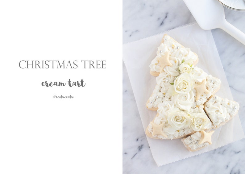 May include: A Christmas tree-shaped cream tart decorated with white frosting, edible flowers, and star-shaped cookies. The tart sits on white parchment paper. Text on the image reads "CHRISTMAS TREE cream tart #cookiecake".