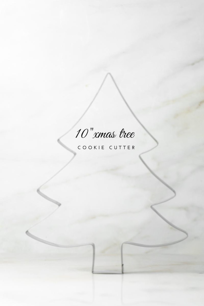 May include: A 10-inch Christmas tree cookie cutter. The metal cutter is in the shape of a stylized evergreen tree. The text "10" xmas tree" and "COOKIE CUTTER" is above the tree outline.
