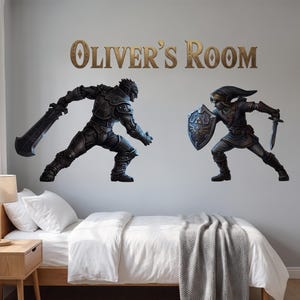 May include: Wall decals featuring the text Oliver's Room in gold lettering above two fantasy characters in combat. One character wears dark armor and holds a large sword, while the other wears a tunic, holds a shield, and wields a small sword.