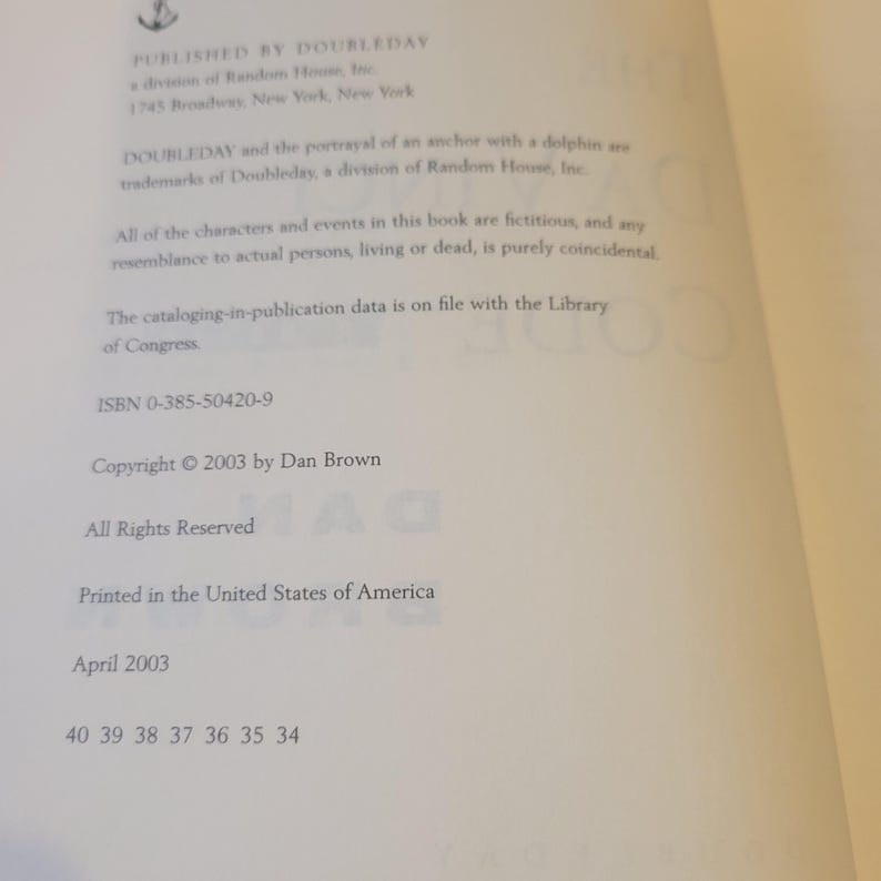 May include: The copyright page of the book The Da Vinci Code by Dan Brown, published by Doubleday in 2003. The text includes the publisher address, ISBN 0-385-50420-9, a disclaimer about fictional characters, and a print run sequence ending in 34.