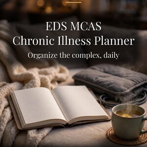 May include: An open blank planner with the text LETS MONEY RESET, EDS MCAS Chronic Illness Planner, Organize the complex, daily, and PRINTABLE PLANNER US LETTER. A steaming mug and a gray heating pad are placed nearby on a soft surface.