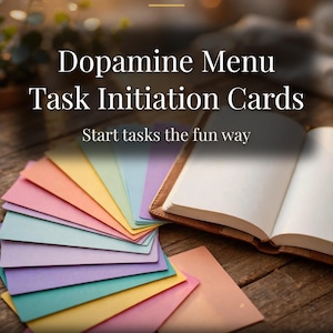 May include: A set of colourful task initiation cards arranged in a fan shape next to an open notebook. The text reads LETS MONEY RESET, Dopamine Menu Task Initiation Cards, Start tasks the fun way, and PRINTABLE PLANNER US LETTER.