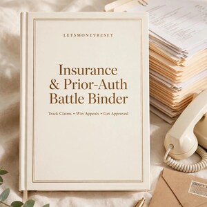 May include: A cream-coloured hardbound binder with gold-toned border lines and brown text that reads: LETS MONEY RESET, Insurance & Prior-Auth Battle Binder, Track Claims, Win Appeals, Get Approved. The binder is positioned upright on a soft surface.