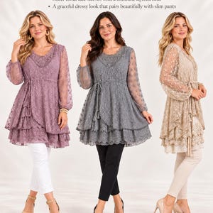May include: Three long-sleeve tunics in mauve, gray, and beige, each featuring floral lace fabric, a scoop neckline with lace trim, a drawstring waist, and a multi-layered hem. The text reads: Romantic Lace Tunic.