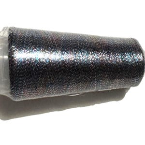 May include: A spool of dark gray thread with a metallic sheen, wrapped in clear plastic. The thread appears to be tightly wound, with a slight texture visible. The spool is set against a white background.