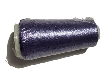 May include: A spool of purple thread wrapped in clear plastic. The thread has a glittery, shimmering appearance. The spool is cylindrical with white ends. Ideal for sewing, embroidery, or other craft projects.