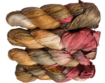 May include: Braided silk ribbon in shades of gold, brown, and rose. The ribbon is tightly woven, with a slightly textured appearance. The colors blend together, creating a rich, layered effect. Ideal for crafting, sewing, or embellishing projects.