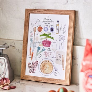 May include: A framed illustration of a chicken pot pie recipe with hand-drawn ingredients and cooking utensils. The title of the recipe is "Nana's Chicken Pie".