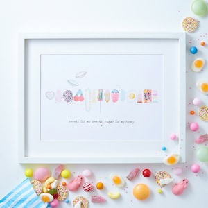 May include: A white framed print with a hand-drawn illustration of various candies and sweets. The text below the illustration reads "sweets for my sweets, sugar for my honey x".