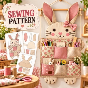 May include: A wall-hanging fabric organizer shaped like a rabbit with six pockets, featuring pink floral and gingham patterns. The organizer includes a bow, button eyes, and embroidered details. Three printed sewing pattern sheets are displayed nearby.