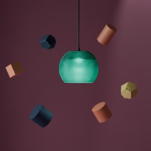May include: A spherical pendant light with a textured green surface hangs from a black cord. Floating around the light are various geometric shapes including a dark blue cube, a tan cylinder, a dark blue cylinder, and a gold-coloured polyhedron.