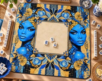 May include: A square mahjong mat featuring a central beige square surrounded by a vibrant blue and gold pattern, including two portraits of individuals with blue skin, floral motifs, and three white mahjong tiles placed in the center.