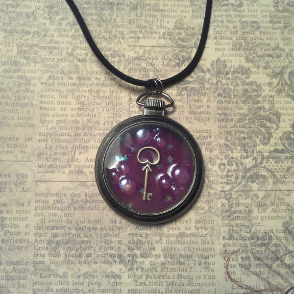 Gunmetal Pocket Watch Style Purple Glow in the Dark Resin Locket with Brass Key Charm, Bubbles, and Stars on Black Velveteen Cord Necklace