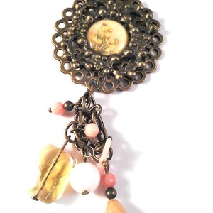 Floral Bronze Frame Pendant with Glossed Yellow Flower Photo Accent and Carious Colors of Beaded Charm Dangle Accents on Necklace