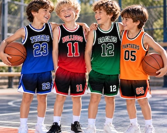 May include: Four basketball uniforms consisting of sleeveless jerseys and matching shorts. The first is blue and black with TIGERS 23, the second red and black with BULLDOGS 11, the third green and black with EAGLES 12, and the fourth orange and black with PANTHERS 05.